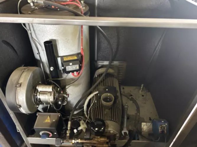 Internal view of Nilfisk SH Truck Booster cabinet before servicing, showing components prior to cleaning and maintenance.